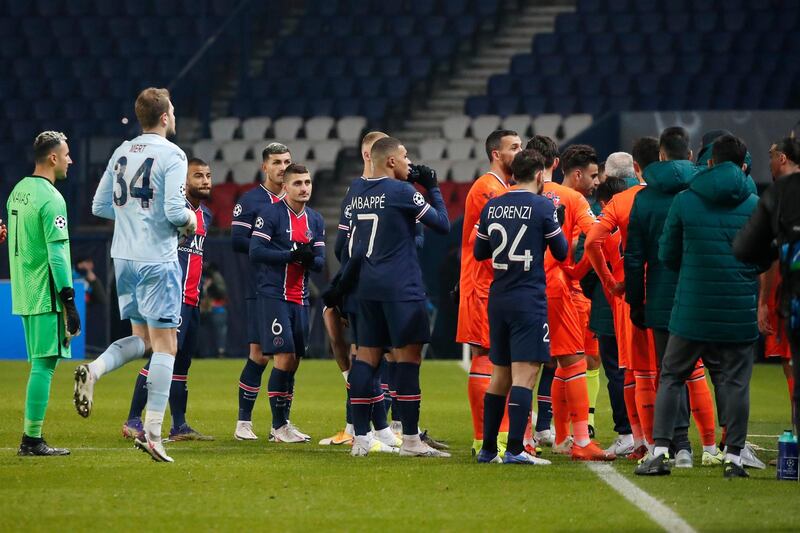 Players of Paris Saint Germain, and Istanbul Basaksehir leave the pitch after the match was suspended following allegations of racist language used by one of the match officials. PA