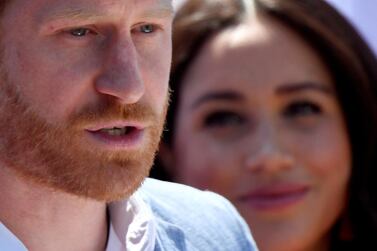 Britain's Prince Harry, Duke of Sussex, gives a speech as his wife Meghan, Duchess of Sussex, looks on, during a visit to the Youth Employment Services (YES) Hub in Tembisa township, near Johannesburg, South Africa, October 2, 2019. REUTERS/Toby Melville/File Photo