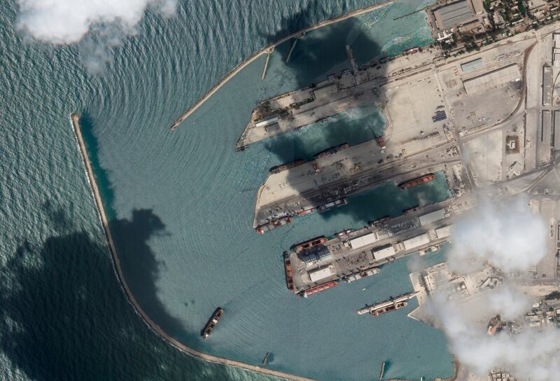 The 'Razoni', centre bottom, identified by its four white cranes on a red deck, docked in Tartus, Syria. AP