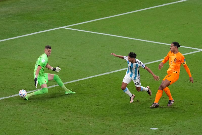 Nahuel Molina finishes past Dutch goalkeeper Andries Noppert to score for Argentina. AP