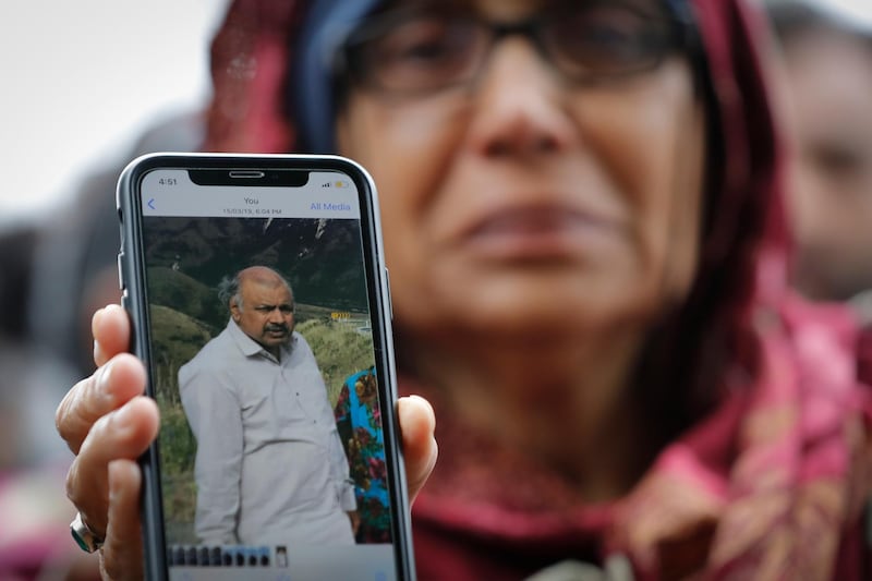 Akhtar Khokhur, 58, shows a picture of her husband Mehaboobbhai Khokhar during an interview outside an information centre for families in Christchurch, New Zealand. AP Photo