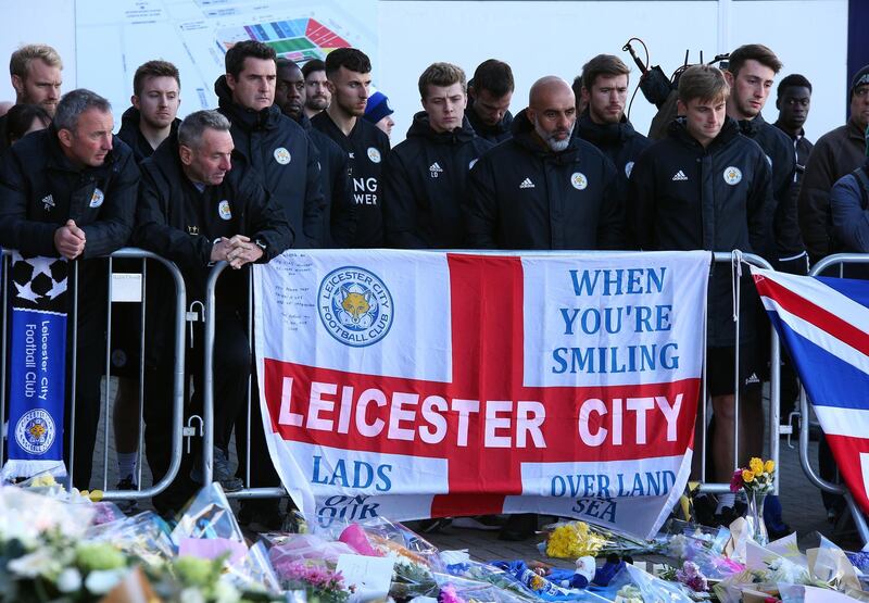 Leicester City players and team members look at flowers and messages of condolence outside the King Power stadium in Leicester, Britain. EPA