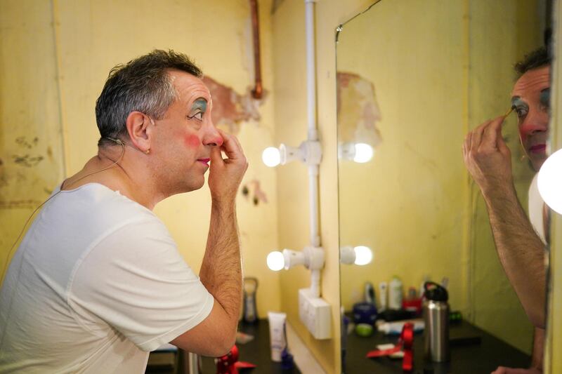 Actor Robin Simpson applies make up as he prepares to play the character of the Dame in Jack and the Beanstalk. Getty Images