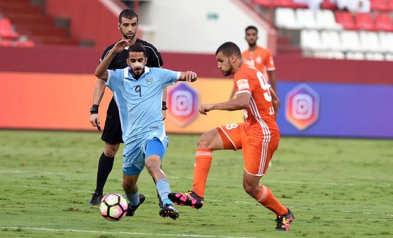Dibba's Ahmed Al-Nuqbi looks to keep possession past a Sharjah defender. Courtesy Arabian Gulf League