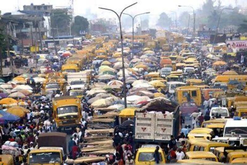 People struggle for space between buses and trucks in Lagos. Africa represents the world's third-largest market. Pius Utomi Ekpei / AFP