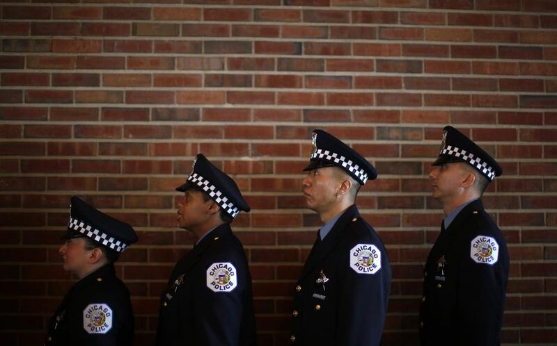 Chicago Police officers line up to be presented their certificates during the graduation ceremony for the Department’s newest recruits in Chicago, Illinois, April 21, 2014. Jim Young /Reuters