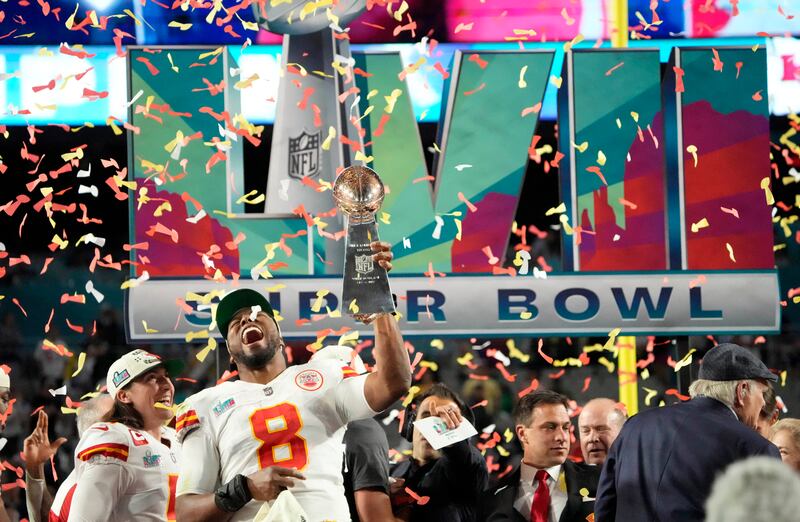 Kansas City Chiefs defensive end Carlos Dunlap (8) celebrates with the the Lombardi Trophy after defeating the Philadelphia Eagles in Super Bowl LVII at State Farm Stadium.  Reuters
