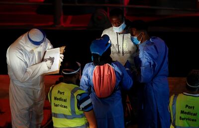 A rescued migrant is being checked by United Nations High Commissioner for Refugees (UNHCR) workers upon his arrival in Senglea, in Valletta's Grand Harbour, as the coronavirus disease (COVID-19) outbreak continues, Malta July 27, 2020. REUTERS/Darrin Zammit Lupi