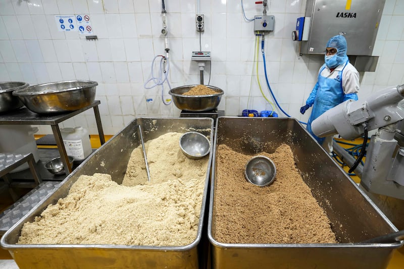 A worker prepares a salicornia plant-based mix to be made into burger patties at a food processing plant, in Sharjah. 