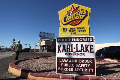 A campaign sign for Arizona Republican gubernatorial candidate Kari Lake is posted in front of a Church's Chicken restaurant in Phoenix, Arizona. Getty Images / AFP