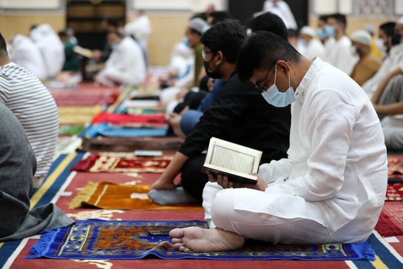 People arrive at Al Farooq Omar Bin Al Khattab Mosque for morning prayers. Chris Whiteoak / The National