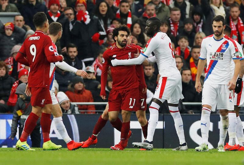 Crystal Palace's Cheikhou Kouyate holds Liverpool's Mohamed Salah back from Crystal Palace's Luka Milivojevic after the penalty flashpoint. Reuters