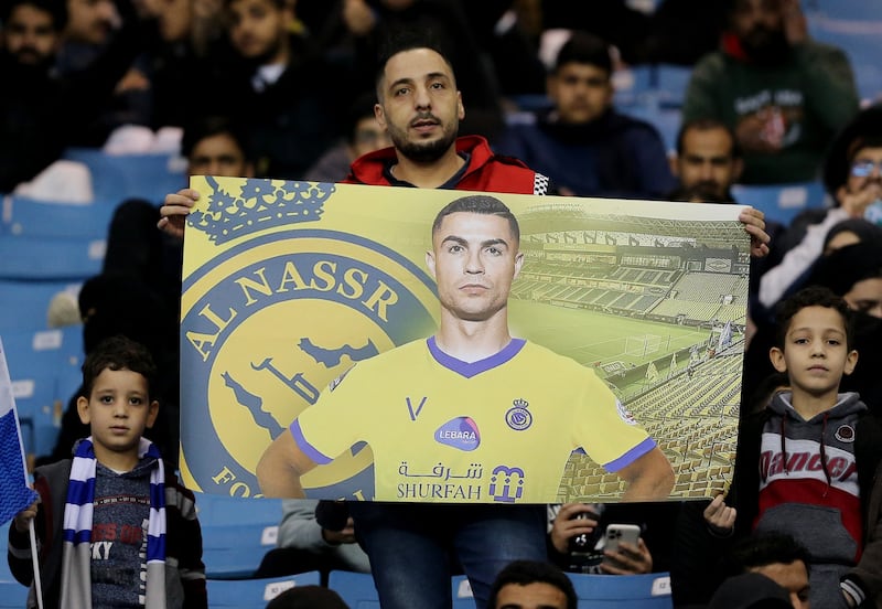 A fan holds up a banner of Al Nassr's Cristiano Ronaldo inside the stadium before the match. Reuters
