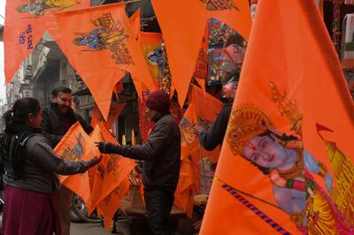 People buy flags printed with pictures of Hindu deity Ram and Ram Temple in Ayodhya, from a shop in Amritsar on January 19, 2024.  AFP
