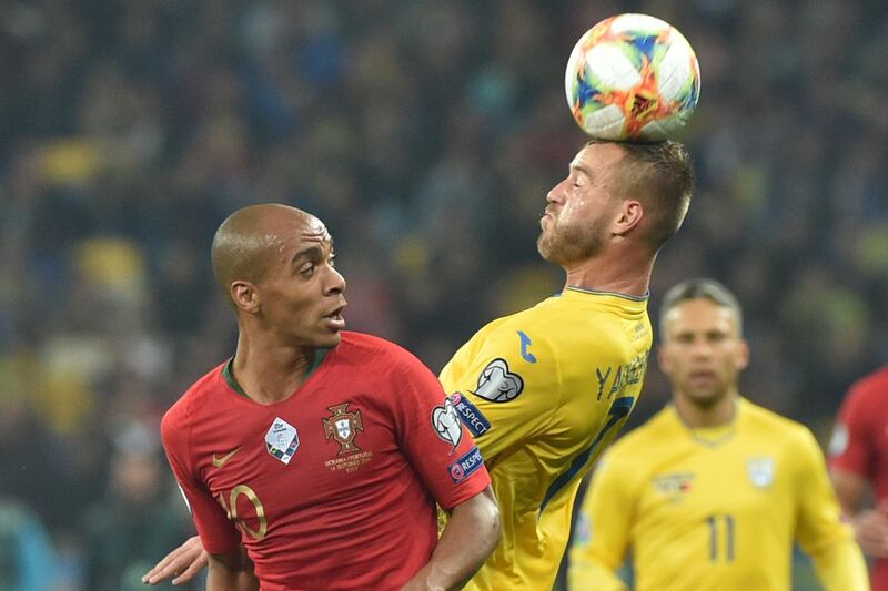 Portugal midfielder Joao Mario and Ukraine forward Andriy Yarmolenko vie for the ball. AFP