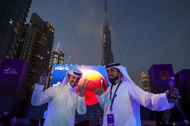 Emirati men pose as they attend an event to mark the Hope Probe's entering the orbit of Mars, near Burj Khalifa, in Dubai, United Arab Emirates, February 9, 2021. Christopher Pike / Reuters