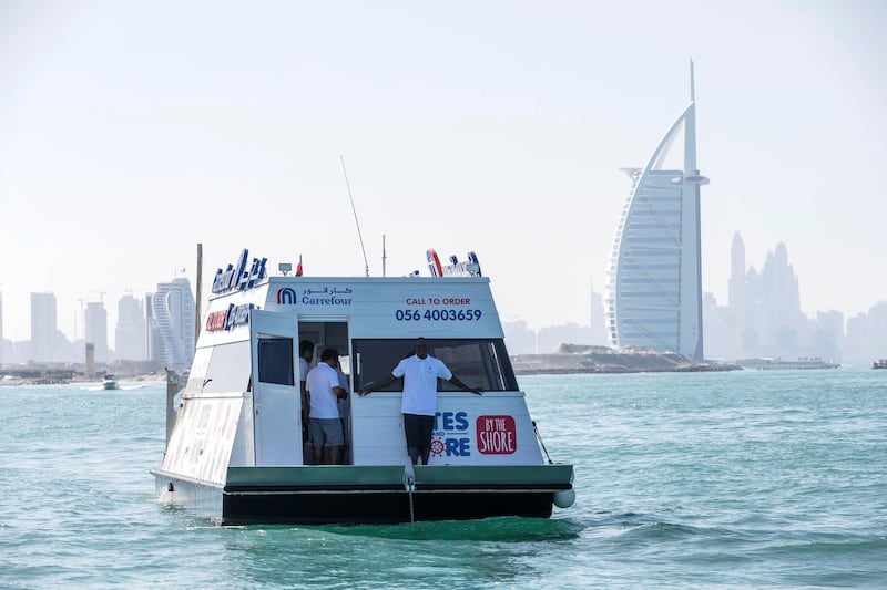 DUBAI, UNITED ARAB EMIRATES. 12 DECEMBER 2018. Trying out the new floating Carrefour mini market off the coast of Dubai. Dubai resident Marie Byrne takes her yacht out to try the new Carrefour floating shop. The floating shop has a nr on the side that sailors can call to get deliveries or their boat /yacht can come alongside to purchase items. (Photo: Antonie Robertson/The National) Journalist: Nicke Webster. Section: National.