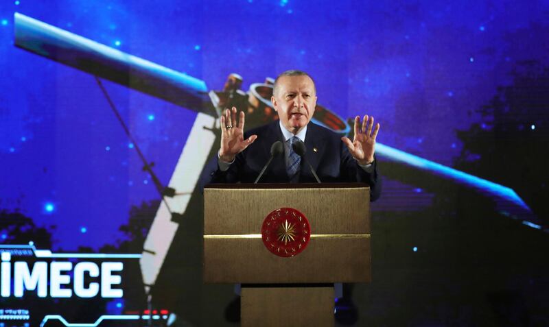 Turkish President Recep Tayyip Erdogan speaks during Turkey's "space program " in Ankara, Turkey, late Tuesday, Feb. 9, 2021. A metal monolith that mysteriously appeared and disappeared on a field in southeast Turkey turned out to be a publicity gimmick ahead of a government event Tuesday during which Erdogan announced a space program for the country. (Turkish Presidency via AP, Pool)