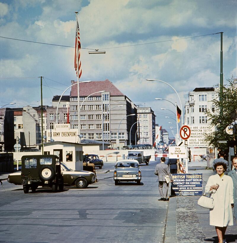 Picture taken in June 1968 of the famous Checkpoint Charlie crossing point, marking the border between East (Soviet sector) and West Berlin (American sector). The Berlin wall built by the East German government to seal off East Berlin from the part of the city occupied by the three main western powers (USA, Great Britain and France), and to prevent mass illegal emigration to the West. The wall, built along the border between German Democratic Republic (GDR) and Federal Republic of Germany, was the scene of the shooting of many East Germans who tried to escape from GDR. The two countries remained divided until November 1989 when the wall was unexpectedly opened following increased pressure for political reform in GDR. (Photo by AFP)
