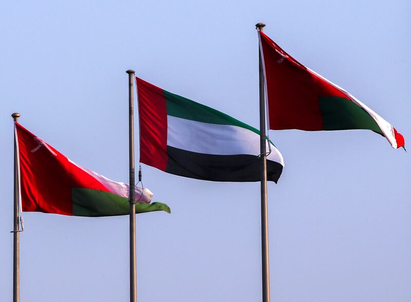 The UAE flag is raised beside the flag of Oman along the Burj Al Sahwa roundabout in Muscat, a day before the arrival of President Sheikh Mohamed. Victor Besa /The National