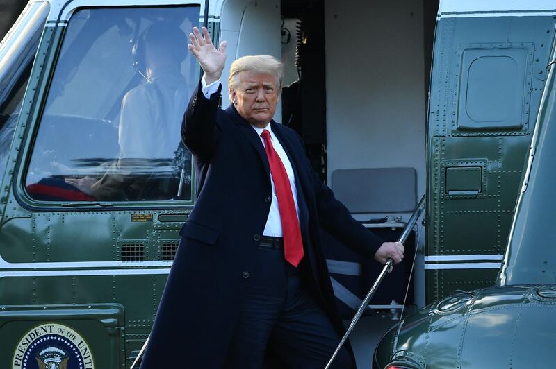 TOPSHOT - Outgoing US President Donald Trump waves as he boards Marine One at the White House in Washington, DC, on January 20, 2021.  President Trump travels his Mar-a-Lago golf club residence in Palm Beach, Florida, and will not attend the inauguration for President-elect Joe Biden. / AFP / MANDEL NGAN
