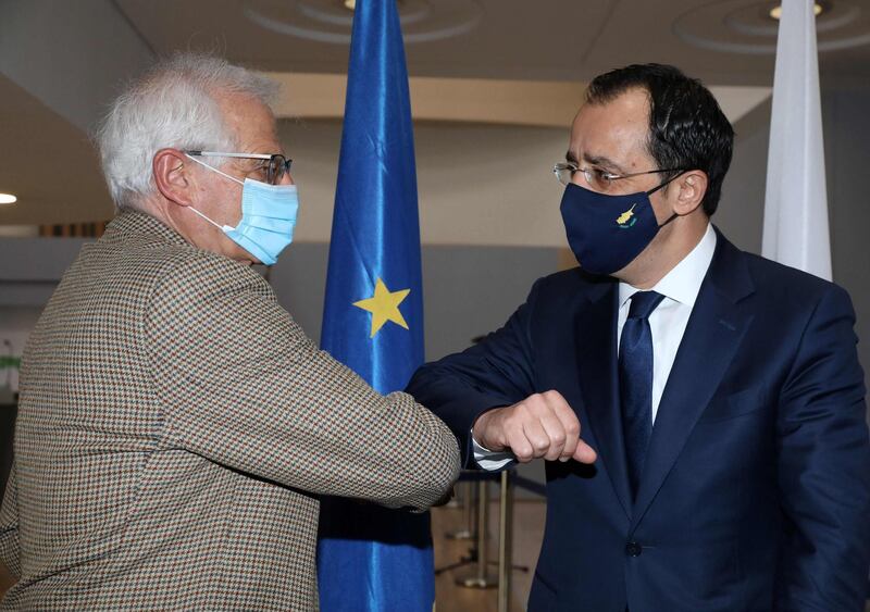 Cypriot Foreign Minister Nikos Christodoulides (R) and European Union High Representative for Foreign Affairs and Security Policy Josep Borrell bump elbows ahead of a meeting at the Ministry of Foreign Affairs in the capital Nicosia, on March 5, 2021, during the the EU diplomat's 2-day working visit to the Mediterranean island. / AFP / POOL / Katia CHRISTODOULOU
