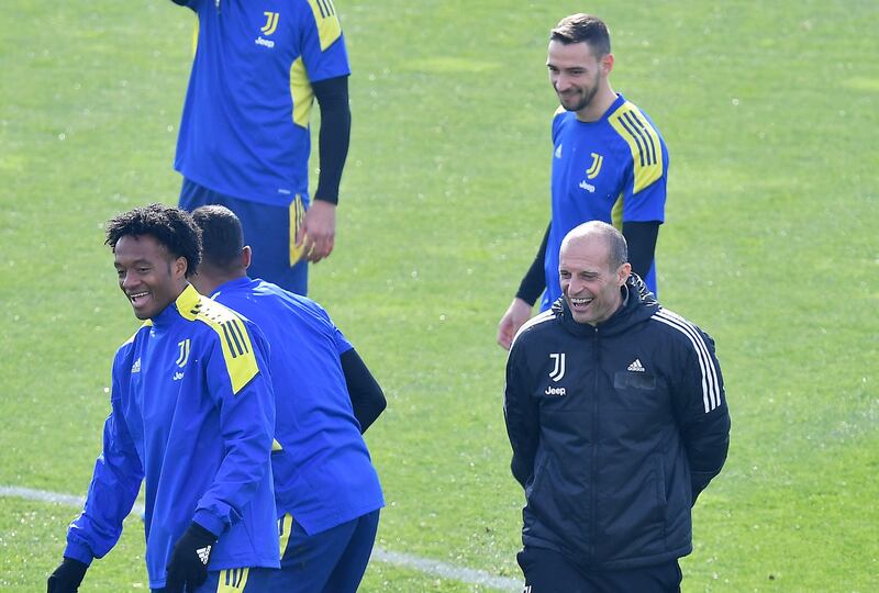 Juventus coach Massimiliano Allegri jokes with his players during a training session for the Villareal match. EPA 