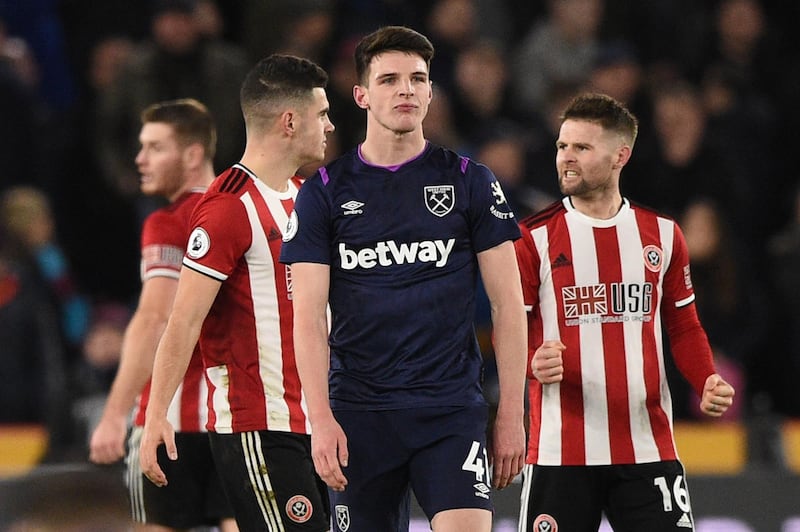 Sheffield United's English-born Northern Irish midfielder Oliver Norwood (R) and other Sheffield United players celebrate after a late West Ham equaliser is ruled out because of a handball in the build up by West Ham United's English midfielder Declan Rice (C) during the English Premier League football match between Sheffield United and West Ham United at Bramall Lane in Sheffield, northern England on January 10, 2020. RESTRICTED TO EDITORIAL USE. No use with unauthorized audio, video, data, fixture lists, club/league logos or 'live' services. Online in-match use limited to 120 images. An additional 40 images may be used in extra time. No video emulation. Social media in-match use limited to 120 images. An additional 40 images may be used in extra time. No use in betting publications, games or single club/league/player publications.
 / AFP / Oli SCARFF                           / RESTRICTED TO EDITORIAL USE. No use with unauthorized audio, video, data, fixture lists, club/league logos or 'live' services. Online in-match use limited to 120 images. An additional 40 images may be used in extra time. No video emulation. Social media in-match use limited to 120 images. An additional 40 images may be used in extra time. No use in betting publications, games or single club/league/player publications.
