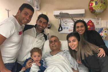 Adeeb Sami, 53, pictured surrounded by his family at Christchurch Hospital, has now been allowed to continue his recovery at home. 