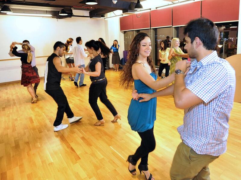 Synthia Agudeto and Ajit Aggarwal, in the forefront, at Capella Club's Salsa class taught by Luis Gabriel Usma. Charles Crowell for The National

