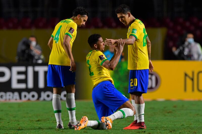 Brazil's Marquinhos, Danilo and Roberto Firmino celebrate at the final whistle. AFP