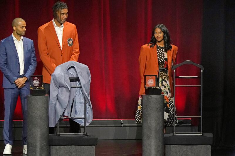 Presenter Tony Parker, left, and Hall of Fame honoree Tim Duncan, second from left, glance over as Natalia Bryant, right, daughter of Kobe Bryant, stands on the stage after her mother, Vanessa, presented her with Bryant's Hall of Fame jacket. AP