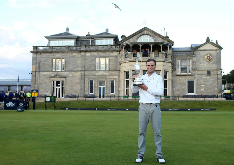 FILE - A Monday, July 20, 2015 file photo of United States' Zach Johnson posing with the claret jug trophy after winning a playoff after the final round at the British Open Golf Championship at the Old Course, St. Andrews, Scotland. The British Open is returning to the home of golf in 2021. The Old Course will host the 150th anniversary of the worldâ€™s oldest major to mark â€œa true celebration of golfâ€™s original championship and its historic ties to St Andrews,â€ the R&A said Monday, Feb. 12, 2018. (AP Photo/Peter Morrison, File)