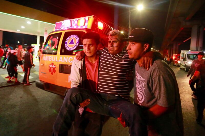 An injured man is helped after a part of Mexico City's subway collapsed. EPA