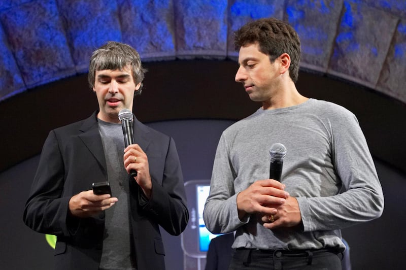FILE PHOTO: Larry Page (L) and Sergey Brin, co-founders of Google, show the new G1 phone running Google's Android software in New York September 23, 2008.  REUTERS/Jacob Silberberg/File Photo