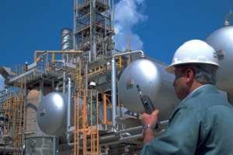 ADNOC FACILITIES

COURTESY ADNOC *** Local Caption *** Man with phone at umm al nar refinery