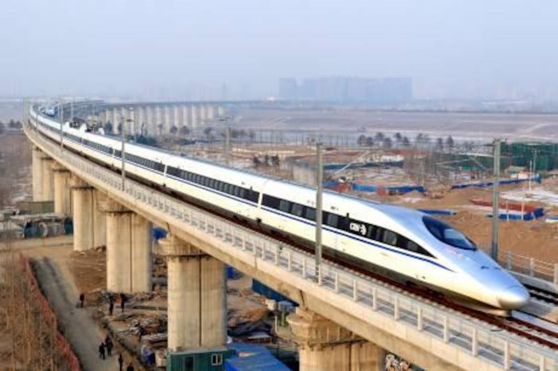 A high-speed train travelling to Guangzhou is seen running on Yongdinghe Bridge in Beijing, December 26, 2012. China opened the world's longest high-speed rail line between Beijing and the southern metropolis of Guangzhou on Wednesday. Picture taken December 26, 2012. REUTERS/China Daily (CHINA - Tags: TRANSPORT BUSINESS) CHINA OUT. NO COMMERCIAL OR EDITORIAL SALES IN CHINA - RTR3BX8F
