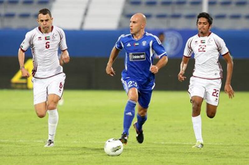 Dubai, United Arab Emirates, Oct 29 2011, Al Nasr v Al Whada-   (centre) Al Nasr's  #23 Mark Bresciano
 works the ball at midfield as (right) Al Wahda's #22 Amer and  (left) #6 Marcio Rodrigues "Magrao" Omar attempts to find position for the block. The Wahda team defeated the Al Nasr squad 1-0 at Al Maktoum Stadium, oct 29 2011.  Mike Young / The National
