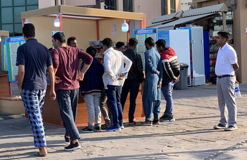 DUBAI, UNITED ARAB EMIRATES , Jan 30  – 2020 :- People trying their luck in the Lucky Games kiosk near the creek in Bur Dubai area in Dubai. ( Pawan  Singh / The National ) For News. Story by Anna