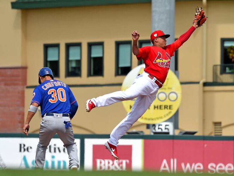 St Louis Cardinals shortstop Yairo Munoz makes a leaping catch as New York Mets left fielder Michael Conforto takes second base at Roger Dean Chevrolet Stadium. Steve Mitchell-USA TODAY