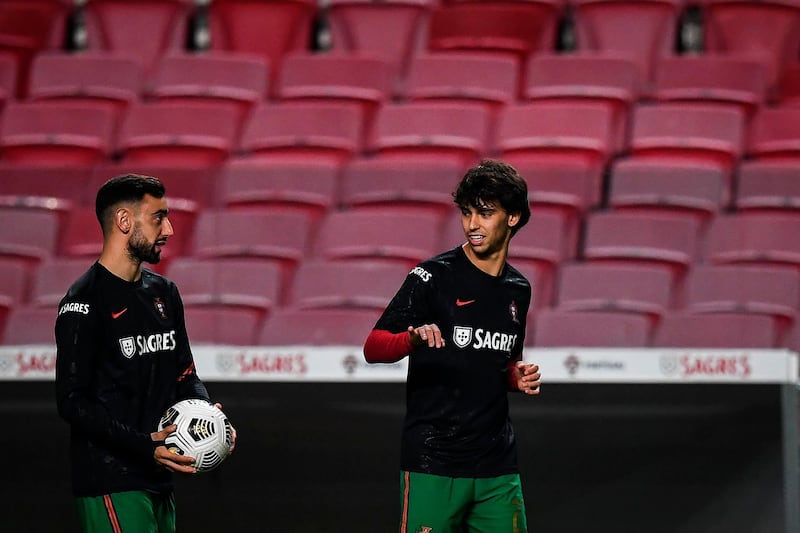 Portugal's Bruno Fernandes and Joao Felix warm up. AFP