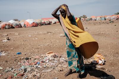 A woman carries a water container at a camp for internally displaced people in Baidoa, Somalia. AFP