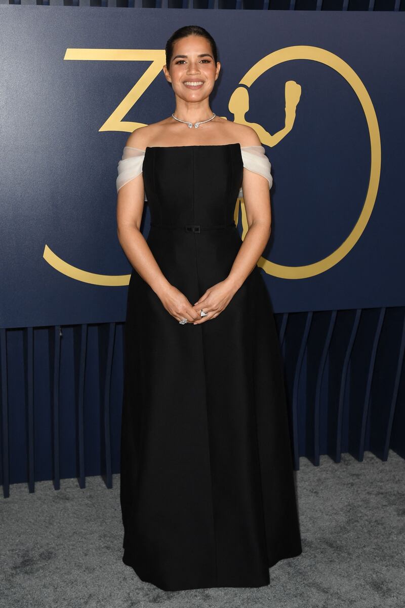 America Ferrera in a black Dior gown with a sheer white off-the-shoulder drape and diamond choker. AP