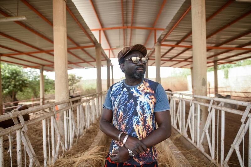 Ba stands in a stable from which he rears cattle adjacent to his Senegal studio. Cooper Inveen / Reuters