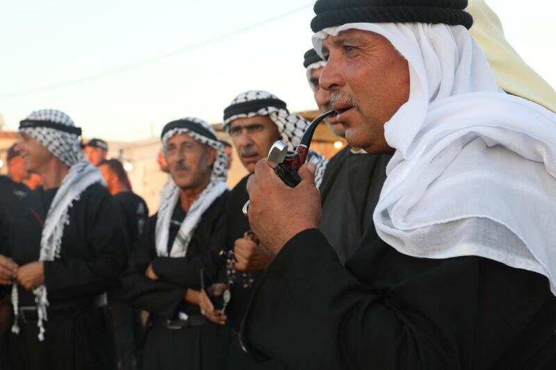 Palestinian farmers celebrate the end of the wheat harvest near Jenin, in the occupied West Bank. EPA