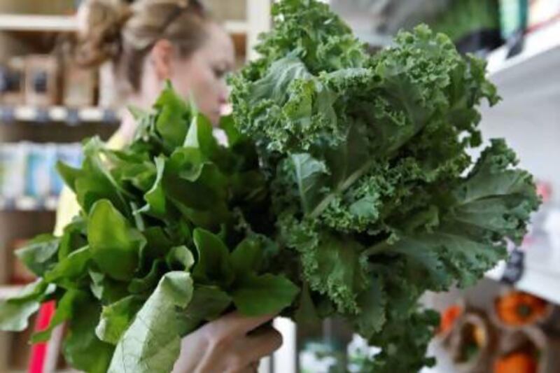 A customer holds kale and rocket at an organic produce shop in Jumeirah. The law will require such items to be properly labelled.