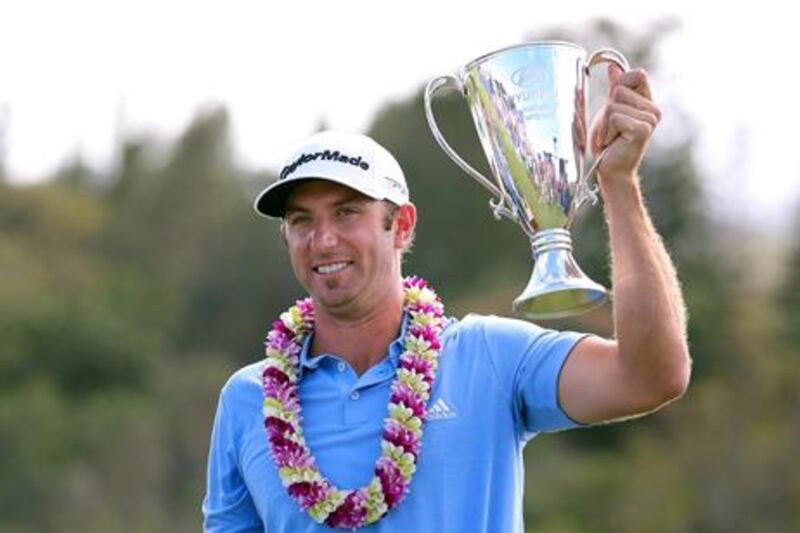 Dustin Johnson celebrates with the Tournament of Champions Cup.