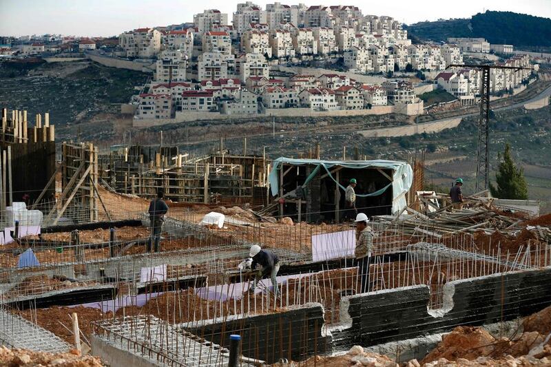 Palestinian labourers work on a construction site in the Israeli settlement of Efrat, situated on the southern outskirts of Bethlehem, on February 1, 2016. Ahmad Gharabli / AFP