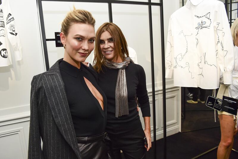 Karlie Kloss and Carine Roitfeld attend the Tribute to the Karl Lagerfeld: The White Shirt Project exhibition as part of Paris Fashion Week on September 25, 2019. Getty Images