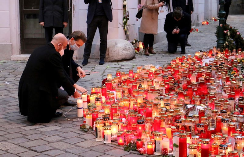 President of the European Council Charles Michel with Austrian Chancellor Sebastian Kurz, right, place candle  tributes to those killed, as they commemorate the terror attack one week ago in Vienna, Austria, Monday, Nov. 9, 2020. Several shots were fired shortly after 8 p.m. local time on Monday, Nov. 2, in a lively street in the city center of Vienna. (AP Photo/Ronald Zak)